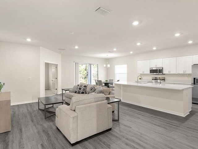 living room with dark hardwood / wood-style floors and sink