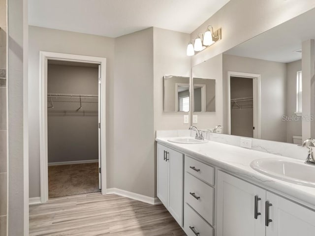 bathroom featuring vanity, hardwood / wood-style floors, and toilet