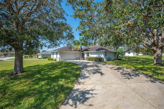 single story home featuring a front yard and a garage