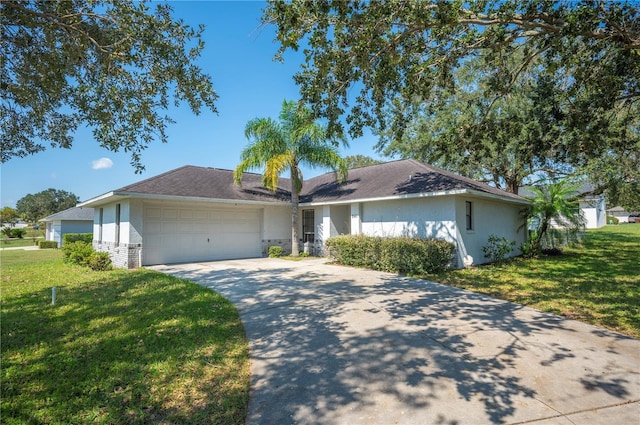 941 Devonshire Way, Lake Wales, FL 33853 - single story home with a front lawn, concrete driveway, an attached garage, and stucco siding