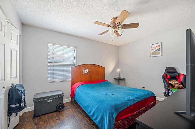 bedroom featuring ceiling fan, a textured ceiling, a closet, and dark hardwood / wood-style flooring