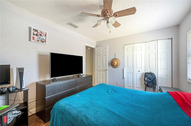 941 Devonshire Way, Lake Wales, FL 33853 - bedroom with a textured ceiling, a ceiling fan, a closet, wood finished floors, and multiple windows