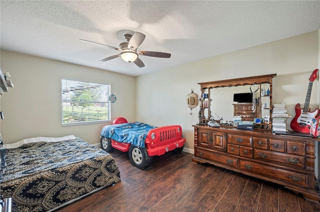 bedroom with dark hardwood / wood-style floors, a textured ceiling, and ceiling fan