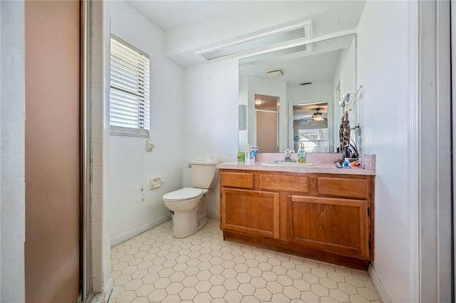 bathroom featuring toilet, vanity, and a shower with door