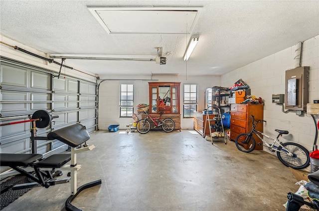 941 Devonshire Way, Lake Wales, FL 33853 - garage with electric panel, a garage door opener, and concrete block wall