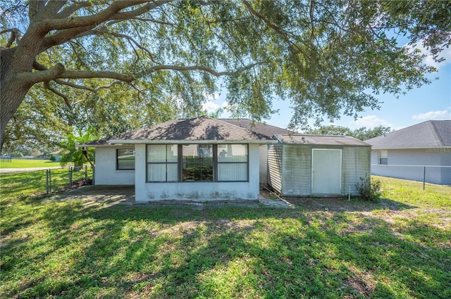 back of house with a lawn