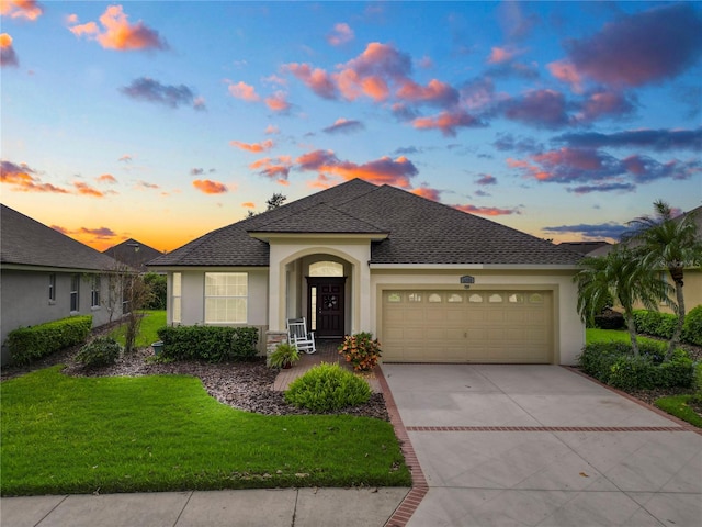 view of front of house featuring a yard and a garage