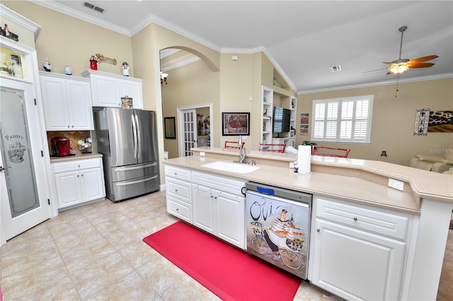 kitchen featuring a kitchen island with sink, stainless steel appliances, ornamental molding, and white cabinets