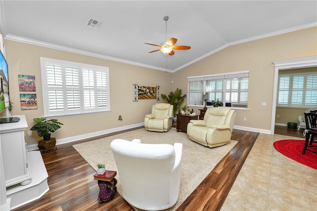 living room with ceiling fan, crown molding, lofted ceiling, and hardwood / wood-style floors