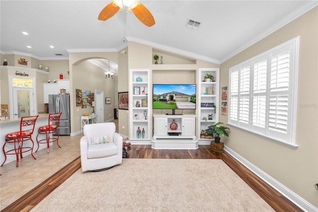 sitting room featuring crown molding, vaulted ceiling, dark hardwood / wood-style flooring, and ceiling fan