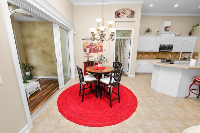 dining room featuring recessed lighting, ornamental molding, and ceiling fan with notable chandelier