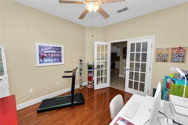 exercise room featuring french doors, dark hardwood / wood-style floors, and ceiling fan