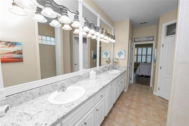 bathroom with a sink, double vanity, ensuite bathroom, visible vents, and a chandelier