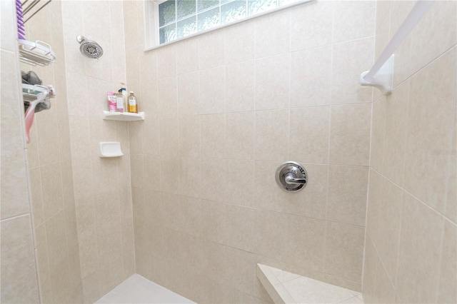 bathroom with a tile shower