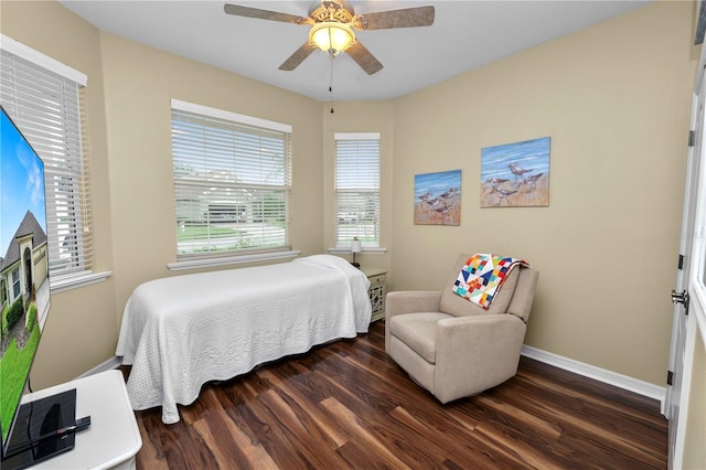 bedroom featuring dark wood-type flooring, a ceiling fan, and baseboards