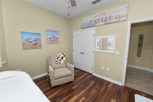 bedroom with dark wood finished floors, visible vents, a ceiling fan, and baseboards