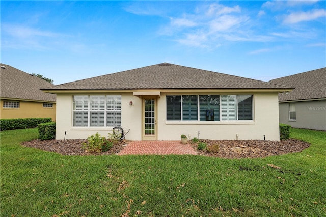 rear view of property with a yard