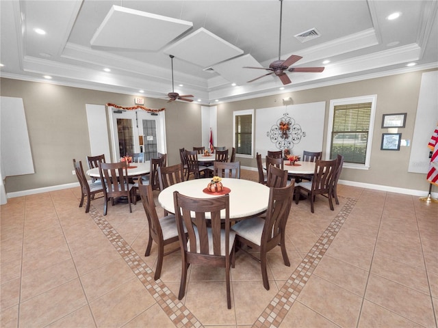 tiled dining room featuring ceiling fan, crown molding, and a raised ceiling