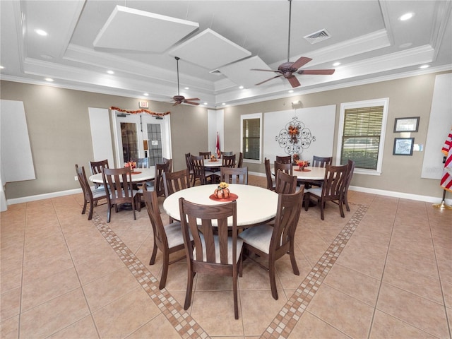 dining space featuring a ceiling fan, a tray ceiling, and light tile patterned floors