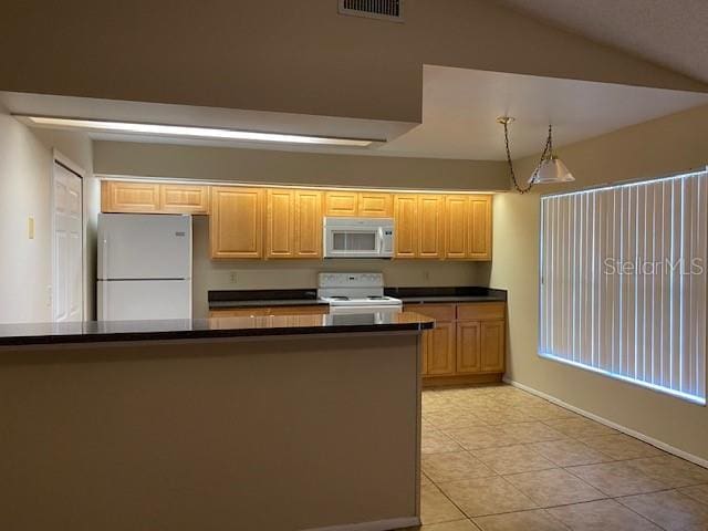 kitchen with white appliances, light brown cabinetry, light tile patterned floors, and vaulted ceiling