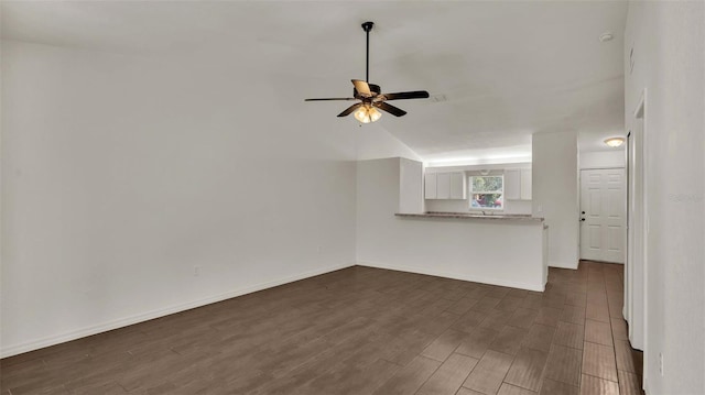 unfurnished living room with baseboards, dark wood finished floors, and a ceiling fan