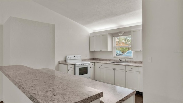 kitchen featuring white electric stove, a peninsula, a sink, white cabinetry, and light countertops