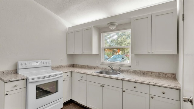 kitchen featuring white electric range oven, light countertops, and a sink