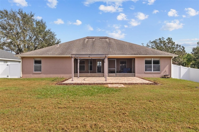 back of property featuring a patio, a sunroom, and a yard