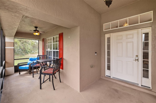 view of exterior entry featuring ceiling fan