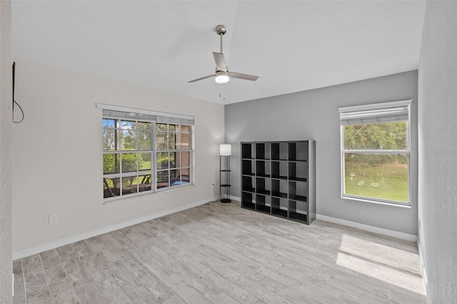 empty room with light wood-type flooring and ceiling fan