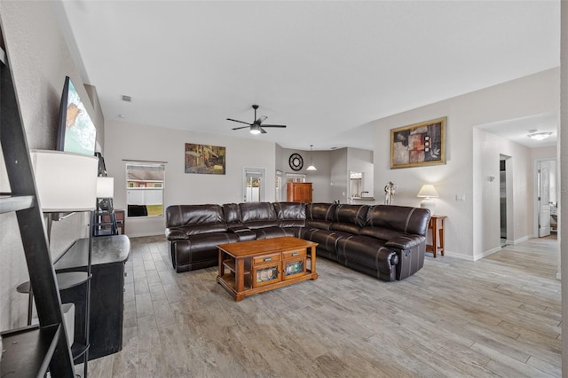 living room featuring ceiling fan and light hardwood / wood-style flooring