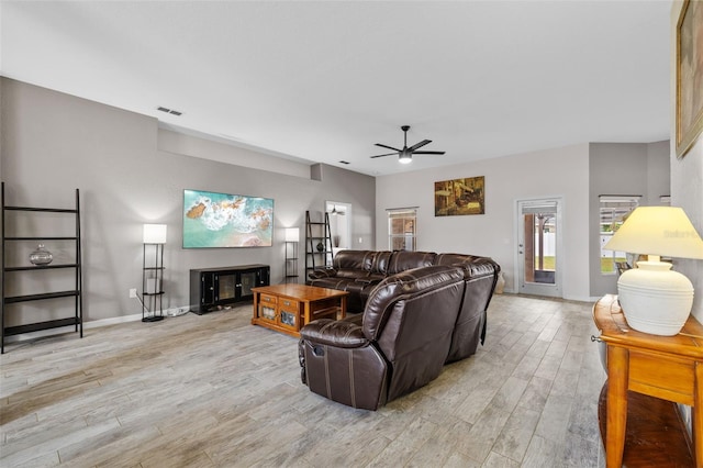 living room featuring light wood-type flooring and ceiling fan