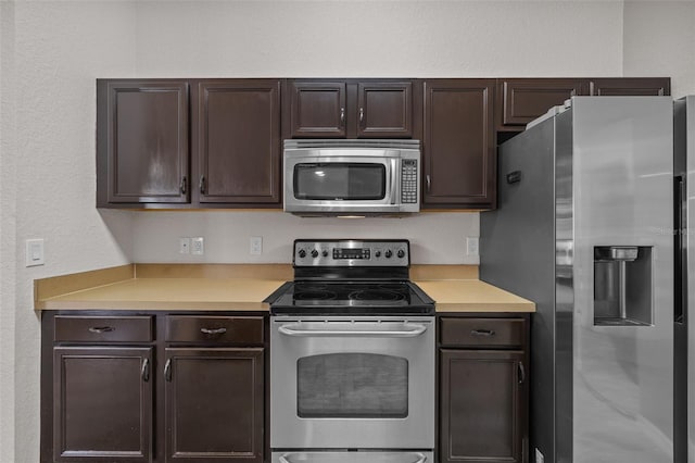 kitchen featuring stainless steel appliances and dark brown cabinets