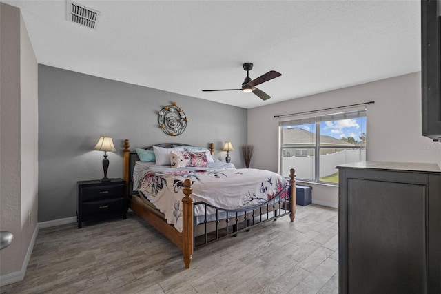 bedroom featuring light hardwood / wood-style floors and ceiling fan