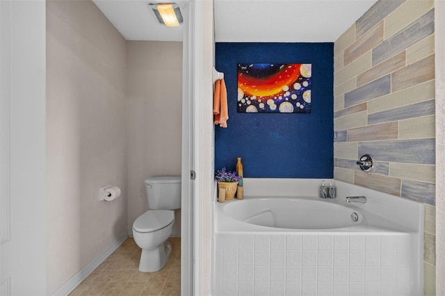 bathroom featuring toilet, tile patterned floors, and tiled tub