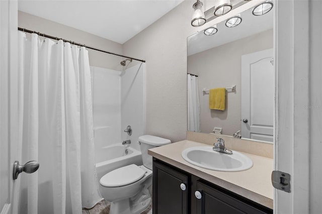 full bathroom with vanity, shower / bath combo, and toilet