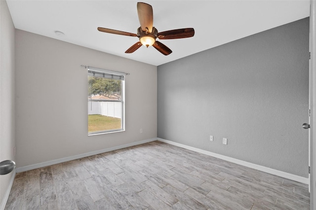 spare room featuring ceiling fan and light hardwood / wood-style flooring