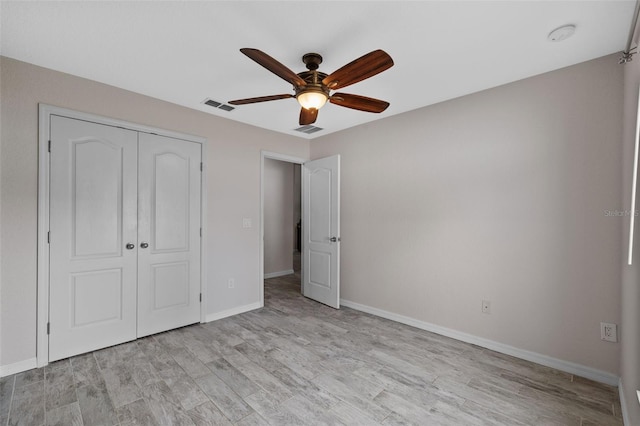 unfurnished bedroom with a closet, light wood-type flooring, and ceiling fan