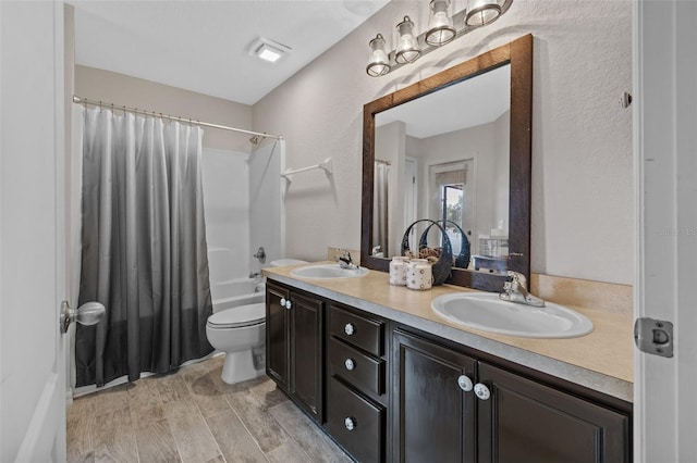 full bathroom with vanity, shower / bathtub combination with curtain, toilet, and wood-type flooring