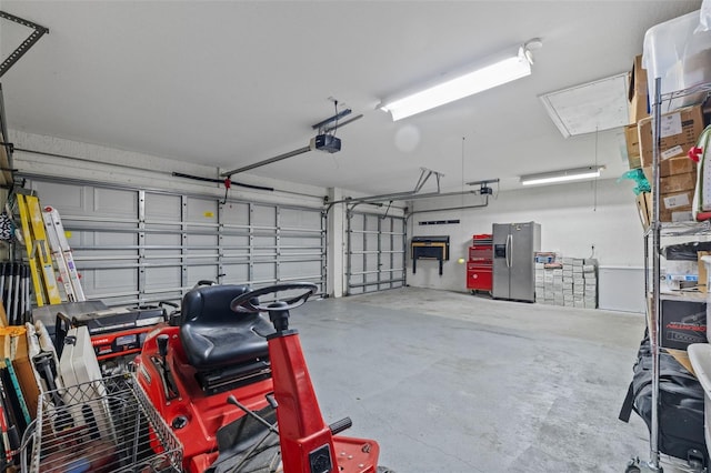 garage featuring a garage door opener and stainless steel fridge with ice dispenser