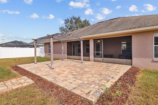 rear view of property with a patio area and a lawn