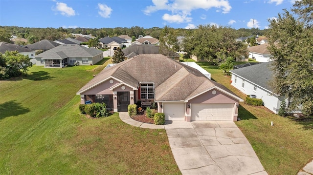 view of front of home with a front yard and a garage