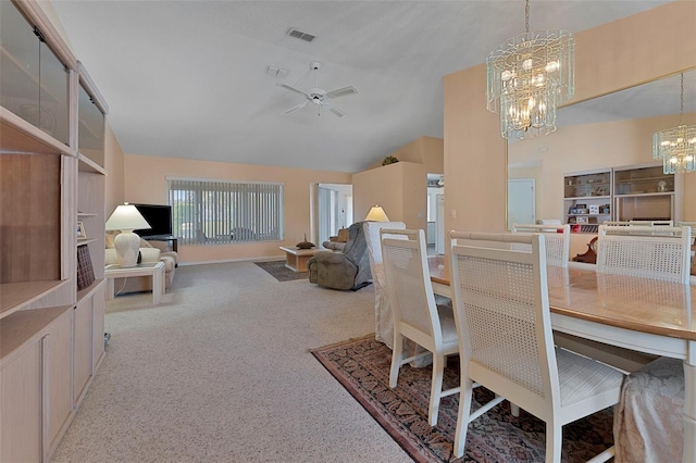 dining room with high vaulted ceiling, carpet, and ceiling fan with notable chandelier