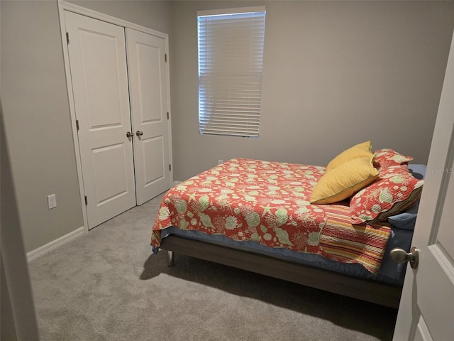 bedroom featuring carpet, a closet, and baseboards