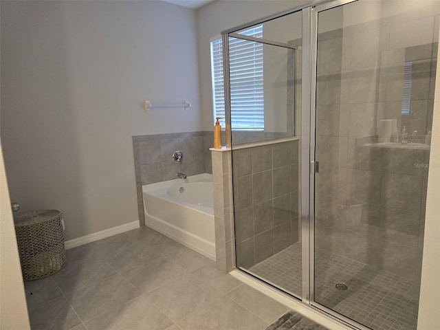 bathroom with a stall shower, tile patterned flooring, and a garden tub