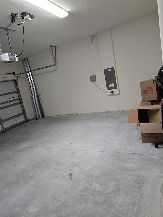 garage featuring electric panel and a garage door opener