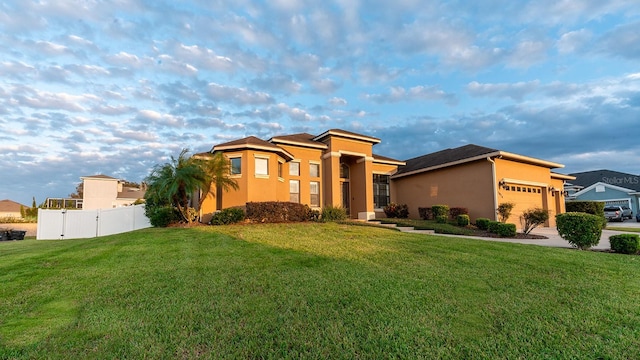 view of front of house featuring a garage and a front lawn