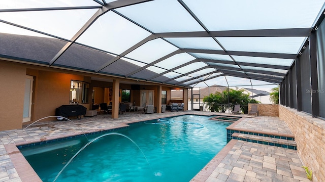 view of swimming pool with a patio, glass enclosure, pool water feature, and an outdoor living space