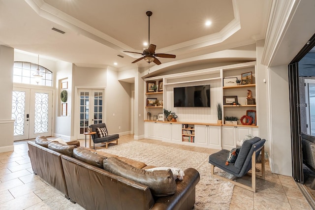 living room featuring ceiling fan, french doors, light tile patterned floors, and ornamental molding