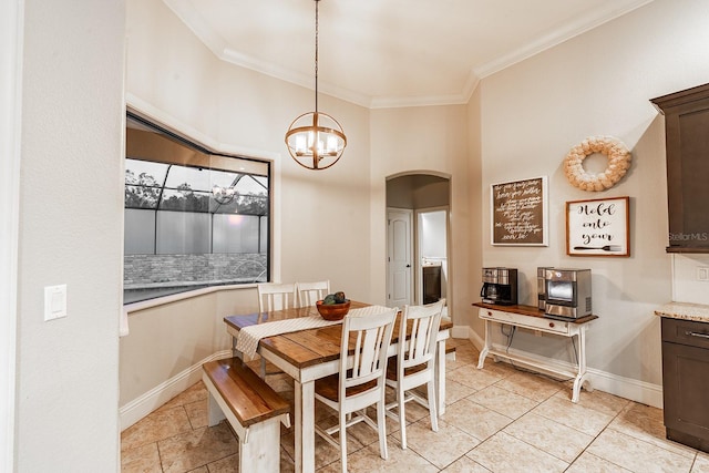 dining area featuring crown molding and an inviting chandelier